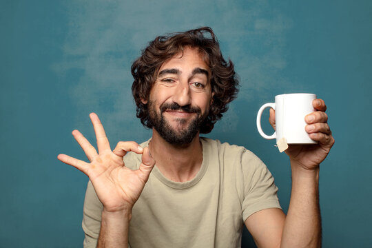 young adult bearded man with a tea mug