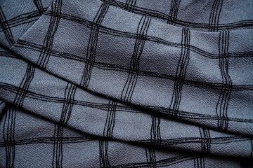 Grey Black white squared pattern table cloth seen from top. Monochrome gray Fabric wave for background. Crumpled cloth abstract texture. Wrinkled fashion fabric. Broken.