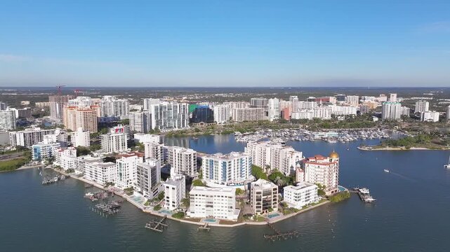 Aerial view of Sarasota's vibrant bayfront buildings with contrasting white structures and blue waters, offering a stunning view, Sarasota, Florida, United States.