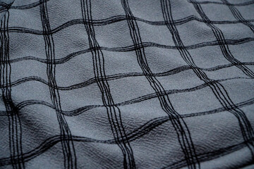 Grey Black white squared pattern table cloth seen from top. Monochrome gray Fabric wave for background. Crumpled cloth abstract texture. Wrinkled fashion fabric. Broken.