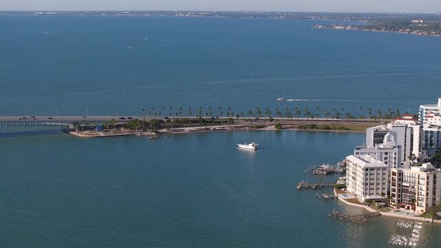 Aerial view of Ringling Bridge stretching over Sarasota Bay with boats sailing through the turquoise waters, Sarasota, Florida, United States.