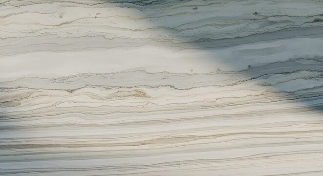 A serene marble surface with intricate patterns and subtle shadows, viewed from directly above, showcasing natural stone texture and elegant design