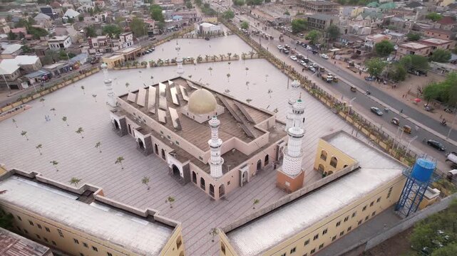 Aerial view of the Kano Central Mosque, its golden dome and solar panels contrasting with the textured courtyard, Kano, Kano state, Nigeria.