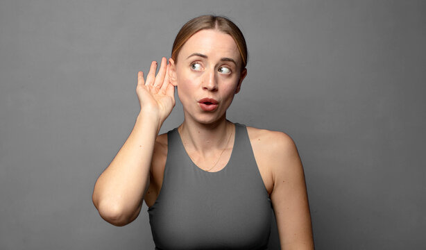 looking serious and curious, listening, trying to hear a secret conversation or gossip, eavesdropping. fitness concept