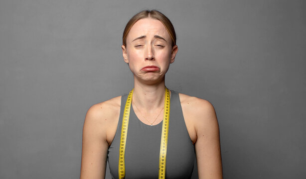 feeling sad and whiney with an unhappy look, crying with a negative and frustrated attitude. fitness concept