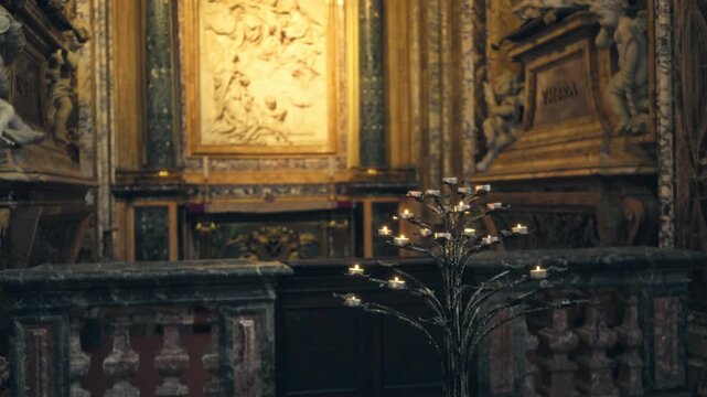Blurred catholic church interior with bokeh altar and lit votive candles background; backdrop copyspace virtual calm.