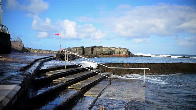 Cinematic aerial of massive Atlantic waves crashing on Gran Canaria coast with dangerous swell and red flag sea conditions