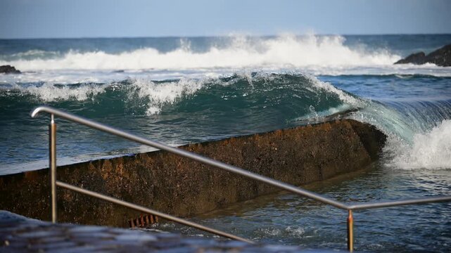 Cinematic aerial of massive Atlantic waves crashing on Gran Canaria coast with dangerous swell and red flag sea conditions
