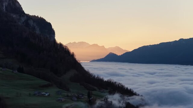 Peaceful sunrise above foggy Swiss Alps near Walensee lake