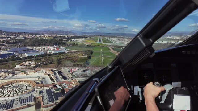 Immersive Pilot&rsquo;s perspective during the final approach to Malaga airport runway (AGP),, with a view of the pilot hand flying manually.
