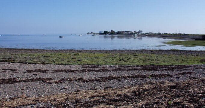 Extra wide panning shot of Roa Island road with roa island in background