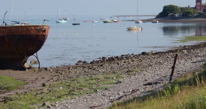 wide panning shot of a Abandoned dialect wreck fishing boat at Roa Island, barrow in furness,