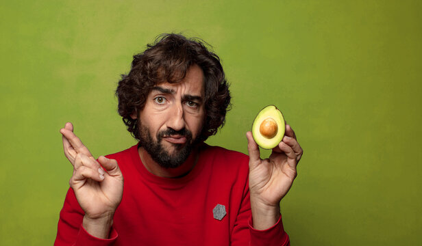 young adult bearded man with an avocado