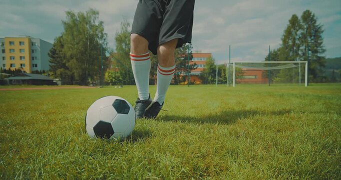 Soccer player with ball in action at stadium.

