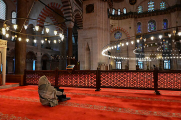 woman in a headscarf inside the Blue Mosque in Istanbul.