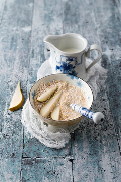 Bowl of popped amarant with milk and slices of pear