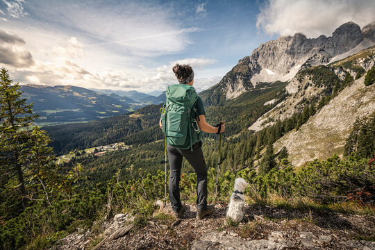 Woman on a hiking trip at Wilder Kaiser enjoying the view, Kaiser mountains, Tyrol, Austria