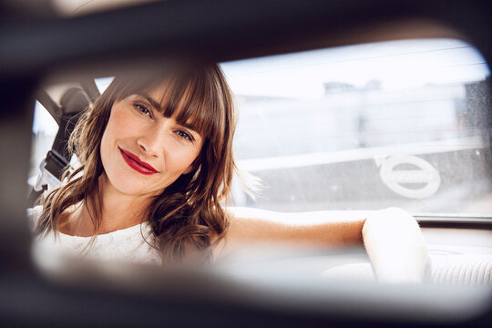 Beautiful woman sitting in vintage car