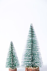 Miniature winter pine trees with snow. Festive christmas and holiday atmosphere, isolated on white background