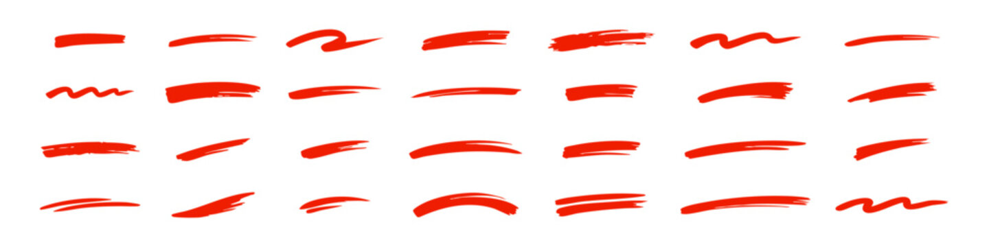 Set of colorful hand-drawn brush strokes, underlines, and paint swatches in black, red, green, and blue on a white background. Vector illustration.