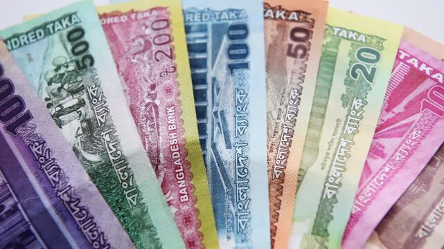 A close up of the Bangladesh currency isolated on white, showing the entire range of bank notes from 1 to 1000 Taka.