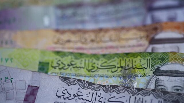 A macro close up downward pan footage of Saudi Riyal bank notes.