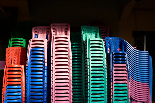 Stacks of coloured plastic chairs