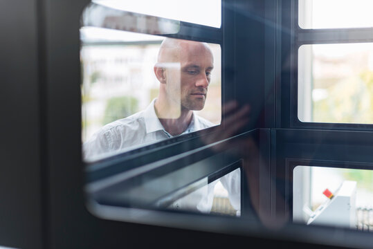Businessman looking into glass box