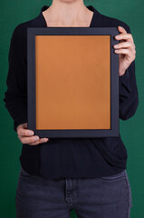 In the decorative background, a woman is holding a picture frame.