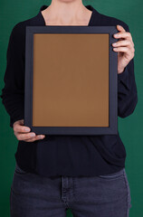 In the decorative background, a woman is holding a picture frame.