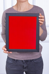 In the decorative background, a woman is holding a picture frame.
