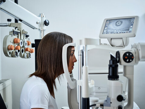 Optician, Young woman during eye test