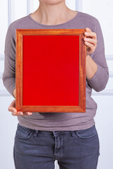 In the decorative background, a woman is holding a picture frame.