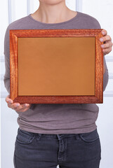 In the decorative background, a woman is holding a picture frame.