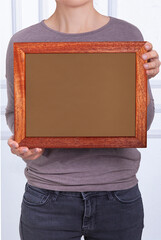 In the decorative background, a woman is holding a picture frame.