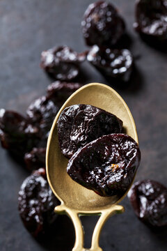 Prunes on a vintage brass spoon