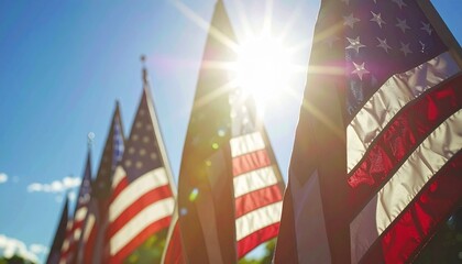 American flags waving proudly in the sunlight against a blue sky.