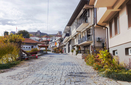 Cobblestone street in Ohrid old town with Samuel Fortress in the background, North Macedonia.