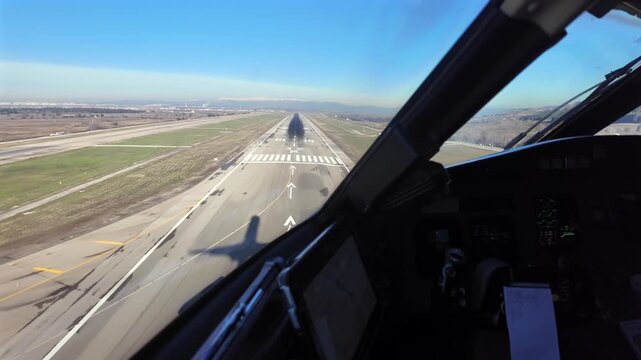 Immersive cockpit view in the final approach to Madrid airport through Pilot Window, with the shadow of the jet on the threshold of runway 32R