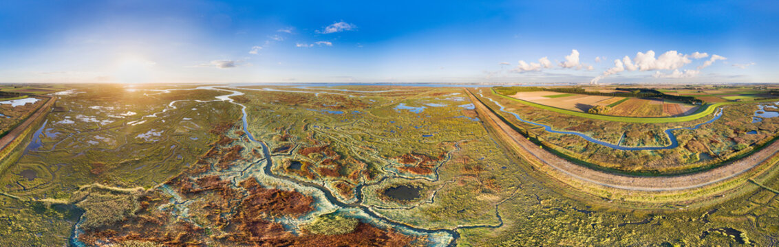 Aerial view of waterways in salt marshlands of Verdronken Land van Saeftinghe, together with polder Hertogin Hedwigepolder in 2016, currently depoldered, in 360 degrees panorama, Zeeland, Netherlands.
