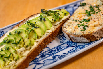 2 sliced bread with avocado and egg spread.
