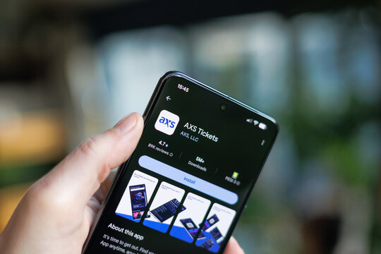 AXS Tickets App on mobile phone in hand in a lifestyle setting