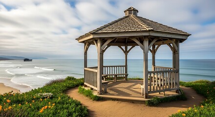 Obraz premium Wooden gazebo on a coastal cliff overlooking the ocean.