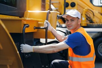 Portrait happy Man driver builder operate excavator at construction site, Industry young worker. © Parilov