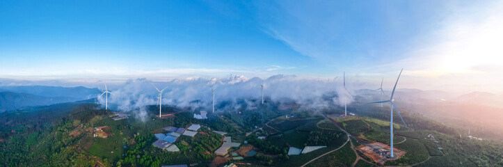 Obraz premium Panoramic aerial view of wind generators in green tea hills of Vietnam. Turbines for electric power production