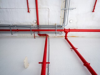 water pipes and electrical tubes on building wall and ceiling