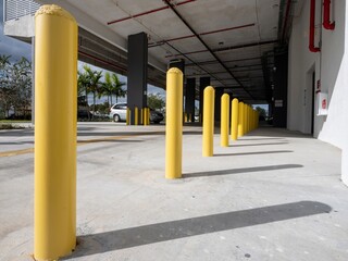 Yellow parking bollards in a car parking garage