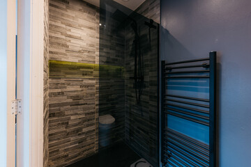 A black and white bathroom with a black and white shower and a black