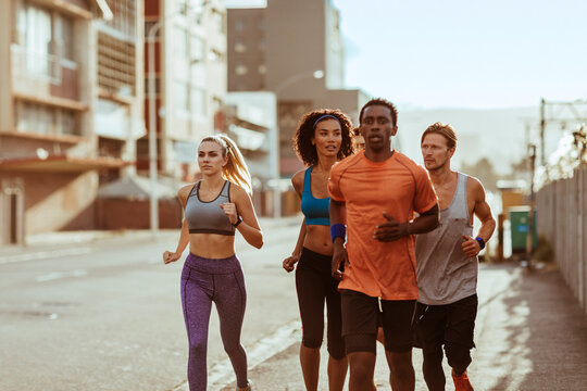 Group of runners training on city street