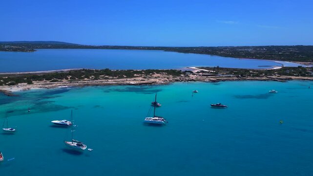 turquoise water coastline with salt flats and boats. Smooth aerial view drone